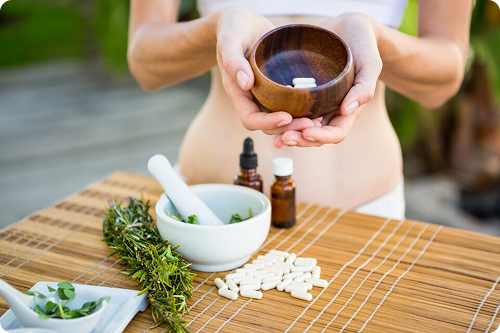 Ayurvedic preparation with mortar, pestle, herbs and oils